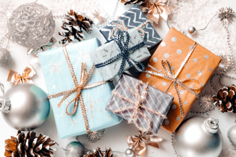 giftwrapped presents surrounded by pinecones and ornaments