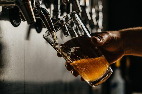 A glass being filled with beer from a spigot