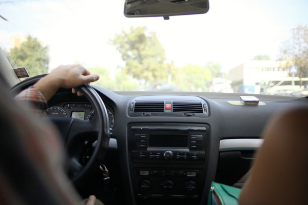 Driver with hands on steering wheel