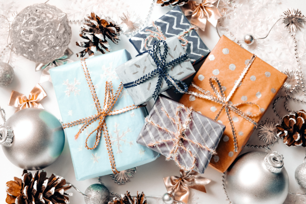 giftwrapped presents surrounded by pinecones and ornaments