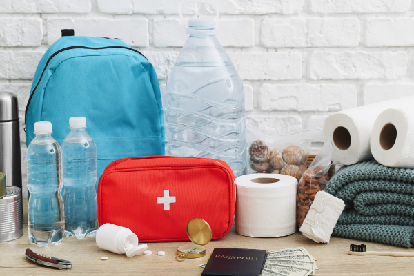 contents of a safety to go bag displayed in front of backpack