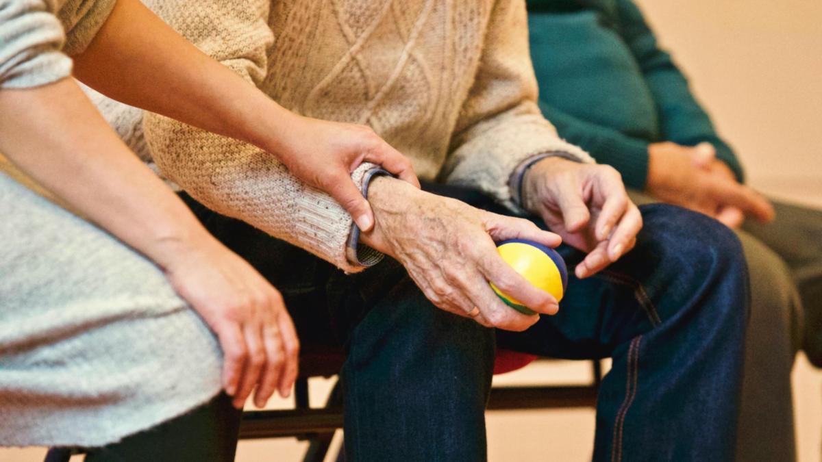 Image of and elderly person who is being attended by a younger person