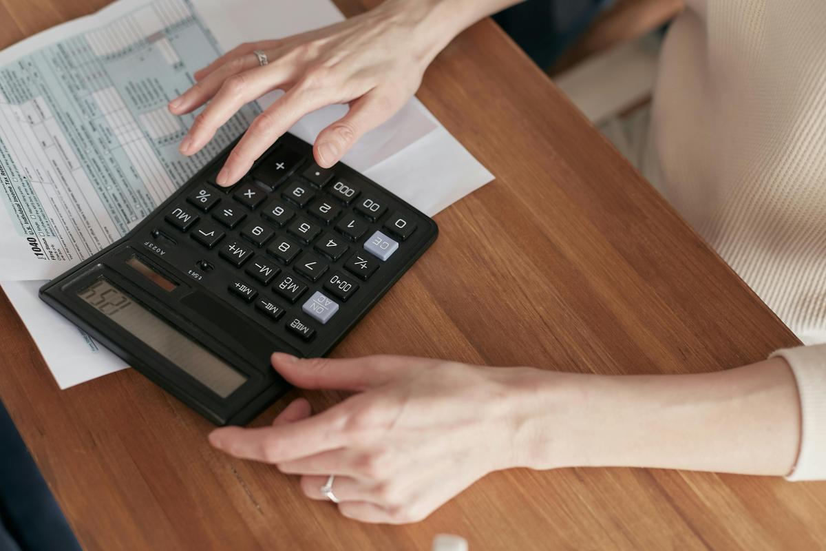 image of a woman with a calculator, a closeup shot